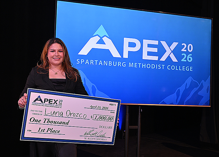 APEX Winner holding big check front of APEX logo.