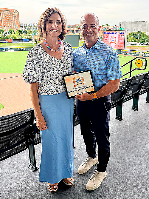 President Cochran holding award with wife.