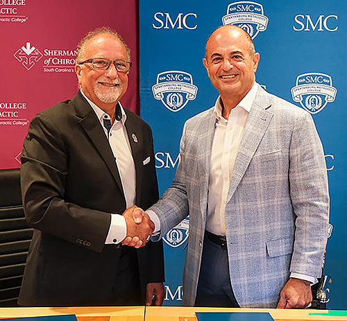 President Cochran and Sherman President Dr. Jack Bourla shaking hands.