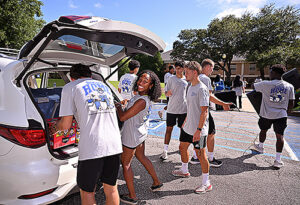 Students unloading a vehicle.