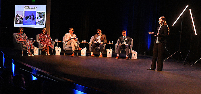 Woman presenting before panel of judges.