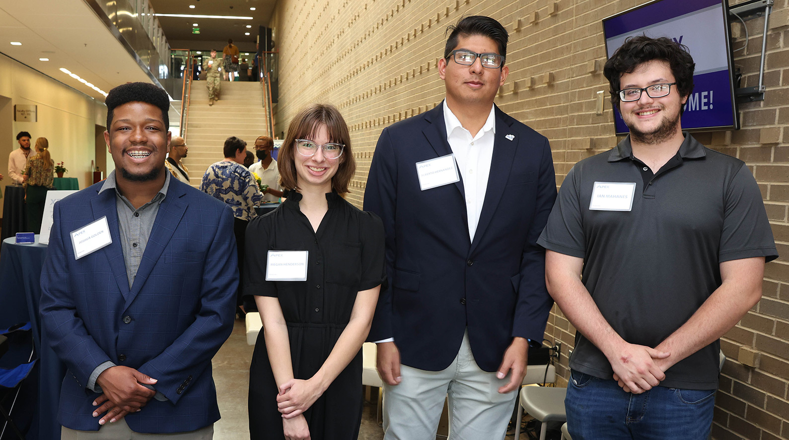Four SMC students standing together at a career event.