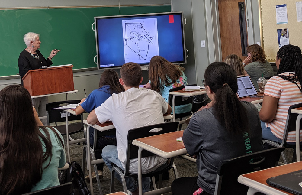 Dr. Kathy Cann, SMC Professor of History (retired) and Professor Emerita, speaks to Camak Core students about the history of the Una, Saxon and Arcadia communities.