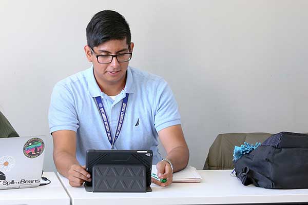 Man in blue shirt using iPad