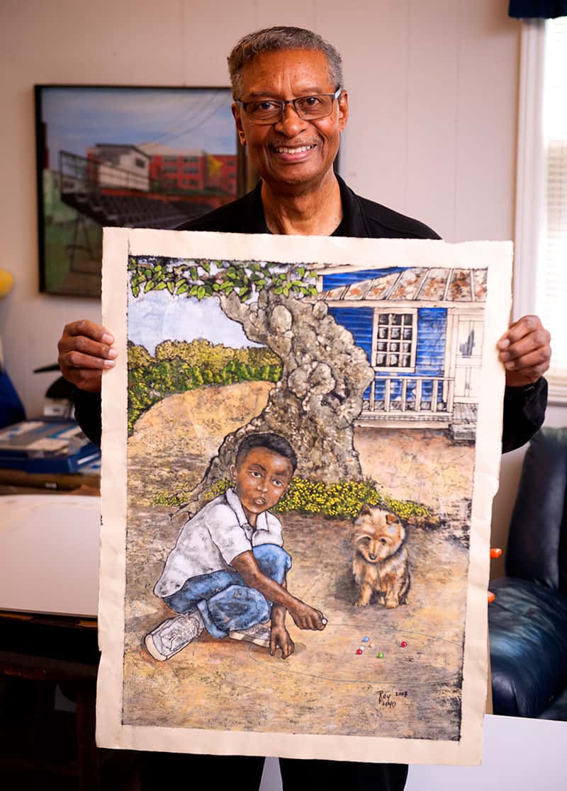 Raymond Floyd holding up painting of boy with dog