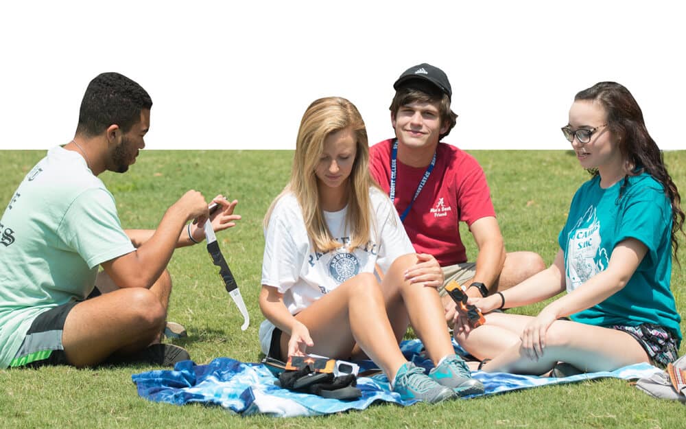 Student sitting on picnic blanket 