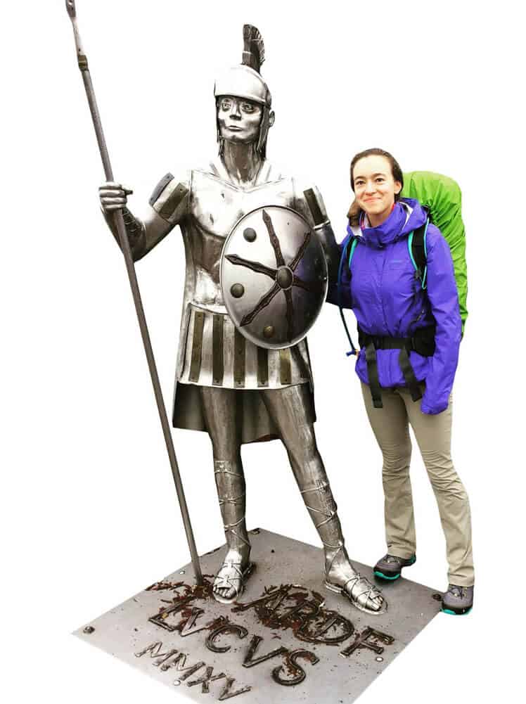 Tania Drahun poses next to a statue of a Roman soldier in Lugo, Spain