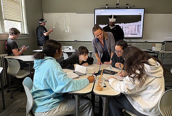Professor Melissa L'Heureux discusses an assignment with students.
