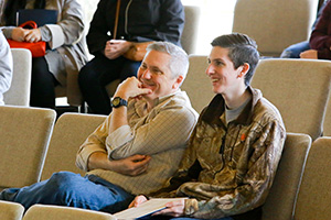 Farther and son listening to a presentation