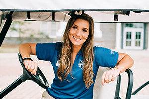Student ambassador sitting in golf cart